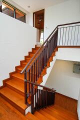 wooden staircase with black railings in a modern home