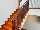 wooden staircase with black railings in a modern home