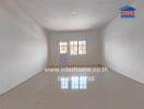 Empty room with tiled floor, large window and white walls