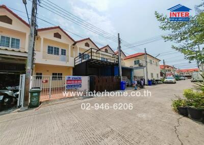 Exterior view of residential buildings with contact information displayed