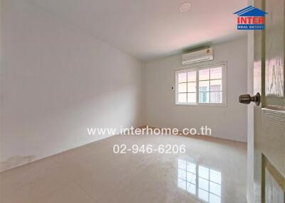 Small empty bedroom with a white wall, air conditioner, window, and tiled floor