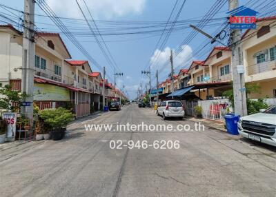 Street view of neighborhood with houses and parked cars