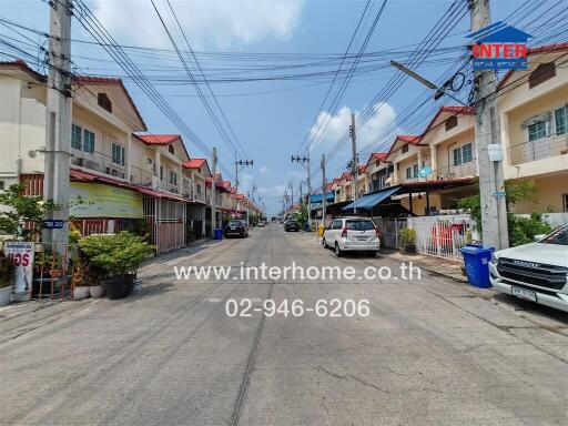 Street view of neighborhood with houses and parked cars