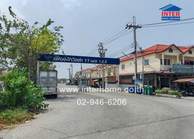 Street view of townhouses and local businesses