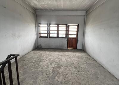 Unfurnished bedroom with windows and a door leading outside