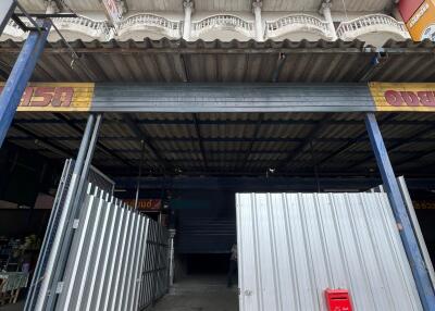 Entrance of an industrial building with a corrugated metal gate