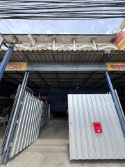 Entrance of an industrial building with a corrugated metal gate