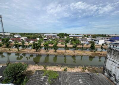 Outdoor view of a neighborhood with houses, trees, and a waterway