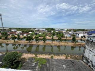 Outdoor view of a neighborhood with houses, trees, and a waterway