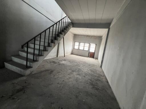 Spacious unfinished interior with staircase