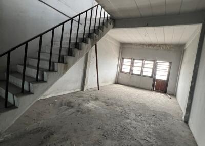 Empty unfinished interior space with staircase