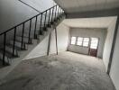 Empty unfinished interior space with staircase