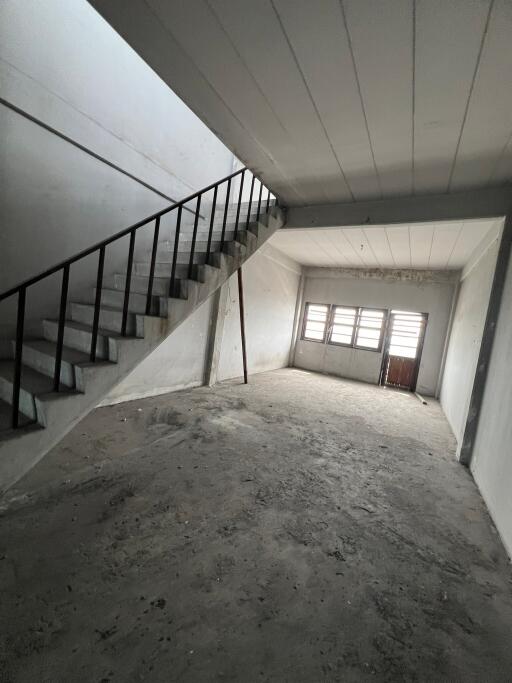 Empty unfinished interior space with staircase