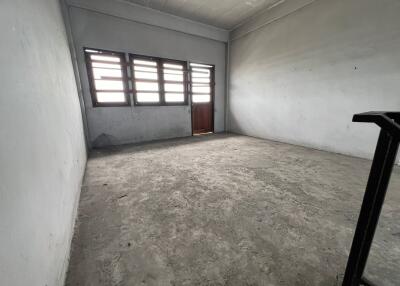 Empty room with concrete floor and windows