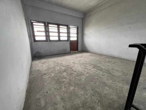 Empty room with concrete floor and windows