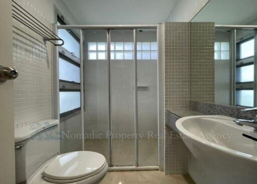 Modern bathroom with a shower, sink, and toilet