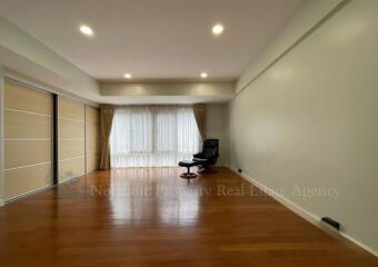 Spacious living room with large windows and natural lighting