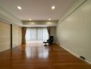 Spacious living room with large windows and natural lighting