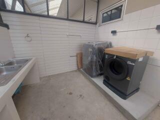 Laundry area with sink and appliances