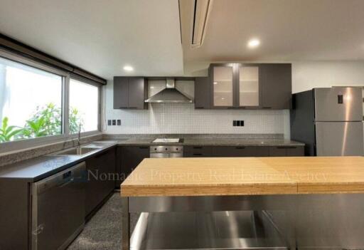 Modern kitchen with stainless steel appliances and wooden countertops