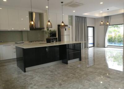 Modern kitchen with a large island and hanging lights