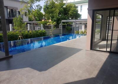 View of a swimming pool area with surrounding patio