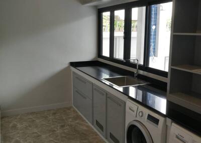 Laundry room with washer, dryer, and sink