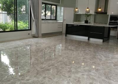 Modern kitchen with large windows and glossy tiled floor