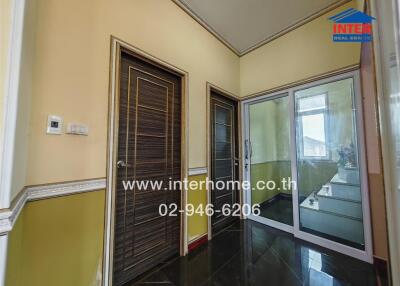 Hallway with wooden door and glass sliding doors