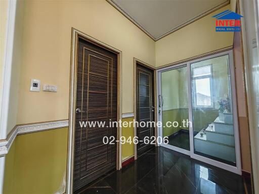 Hallway with wooden door and glass sliding doors