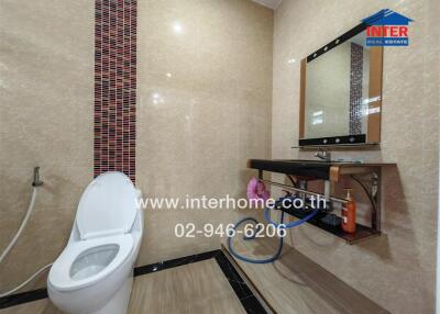 Modern bathroom with tiled walls and a sleek vanity area