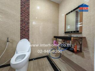 Modern bathroom with tiled walls and a sleek vanity area