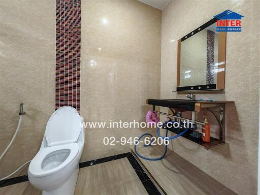 Modern bathroom with tiled walls and a sleek vanity area