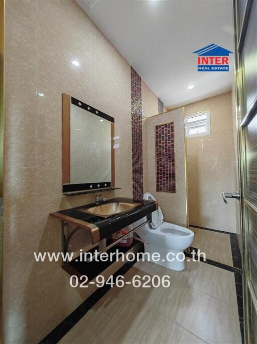 Modern bathroom with vanity, mirror, and toilet