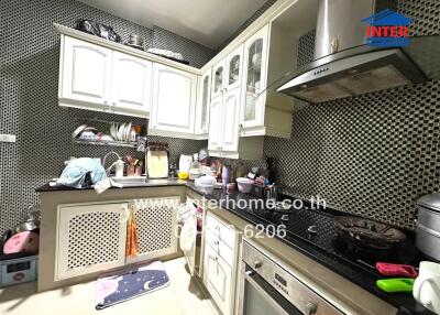 Modern kitchen with white cabinetry and various appliances