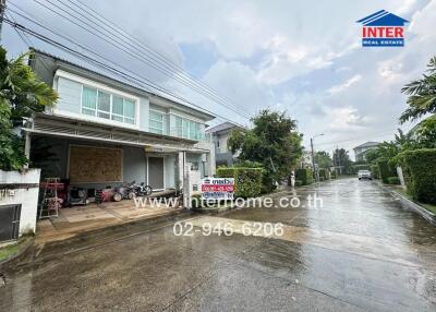 Front view of a modern house with a driveway and garage