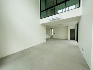 spacious living area with high ceiling