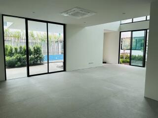 Spacious living room with large windows and garden view