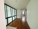 Bright hallway with wooden flooring and modern glass panel doors