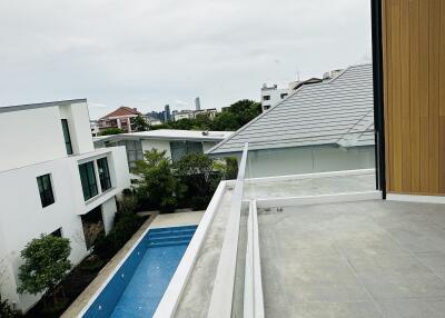 View from the balcony overlooking the pool and neighboring buildings