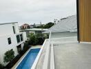 View from the balcony overlooking the pool and neighboring buildings