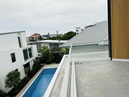 View from the balcony overlooking the pool and neighboring buildings