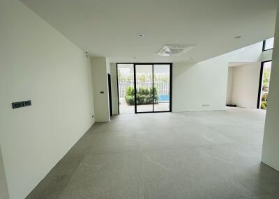 Spacious living room with large glass doors leading to an outdoor area