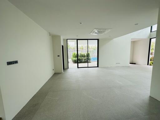 Spacious living room with large glass doors leading to an outdoor area