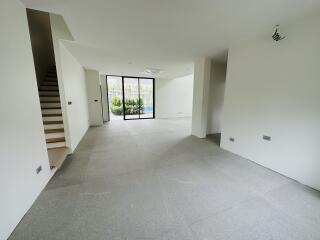 Modern living room with large windows and garden view