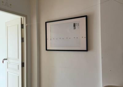 Minimalist room with framed art and white door