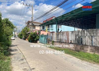 Street view of neighborhood with residential houses and power lines