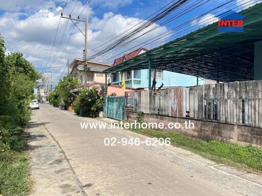 Street view of neighborhood with residential houses and power lines