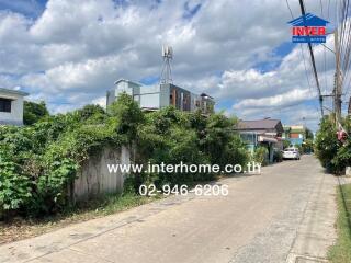 View of residential street with houses and greenery