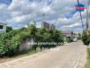 View of residential street with houses and greenery